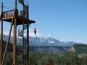 Woman launching from zipline over mountains