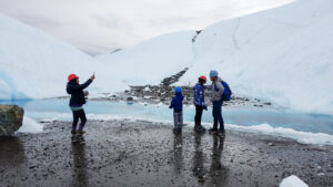 people looking at ice overhang on Matanuska Glacier