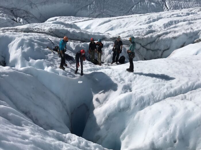 group of people on glacier