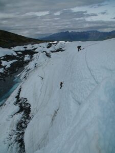 people scaling down ice walls