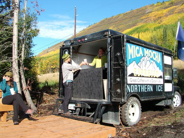 a person serving espresso out of a truck