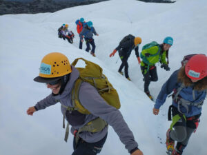 line of people on ice with helmets on