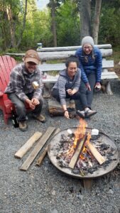 people making marshmallows on a fire