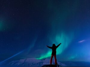 person in front of Northern Lights