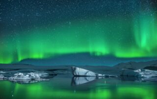 northern lights over coastal waters