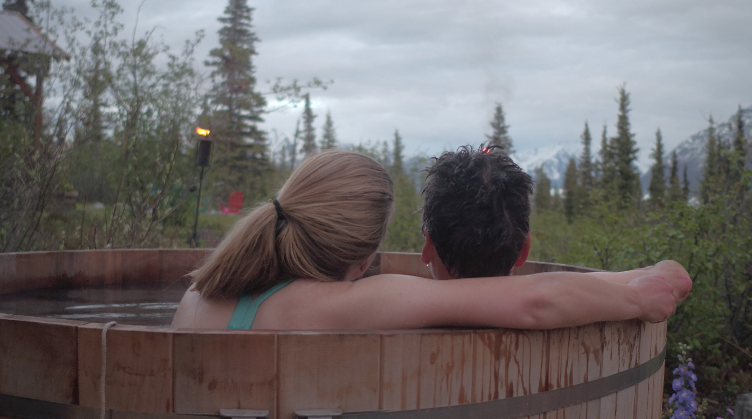 couple in a hot tub looking into the distance