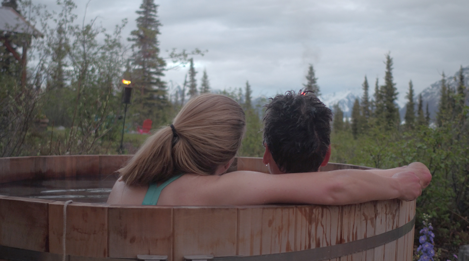 couple sitting in a hot tub looking out into the distance