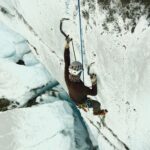 ice climber on Matanuska Glacier ascends ice wall