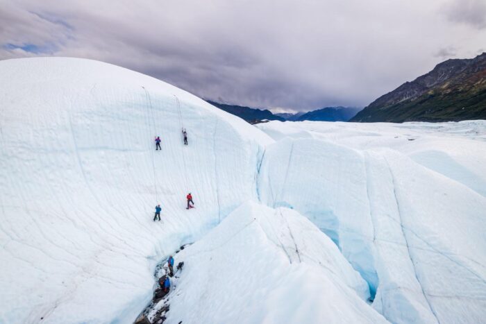 multiple ice climbers on giant ice wall