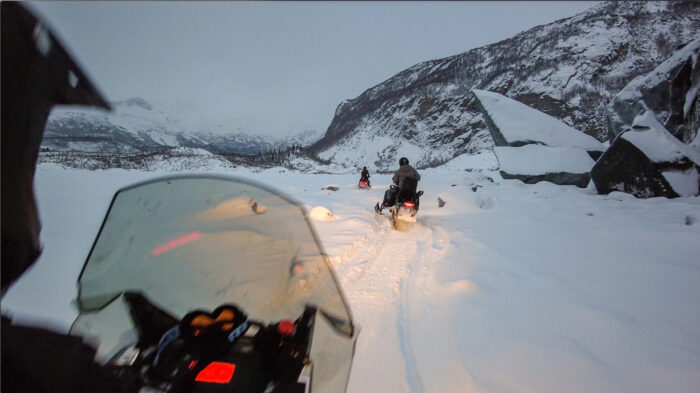 POV snowmobilers on Alaska glacier